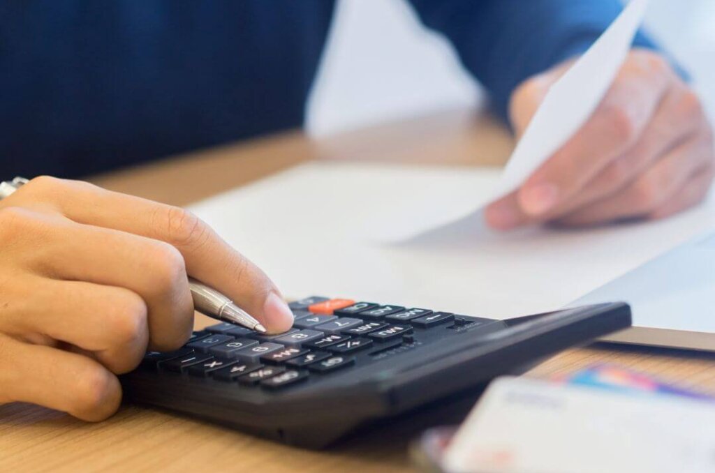 Strategies For Managing Your Money During Times Of Financial Uncertainty man reviewing his monthly expenses